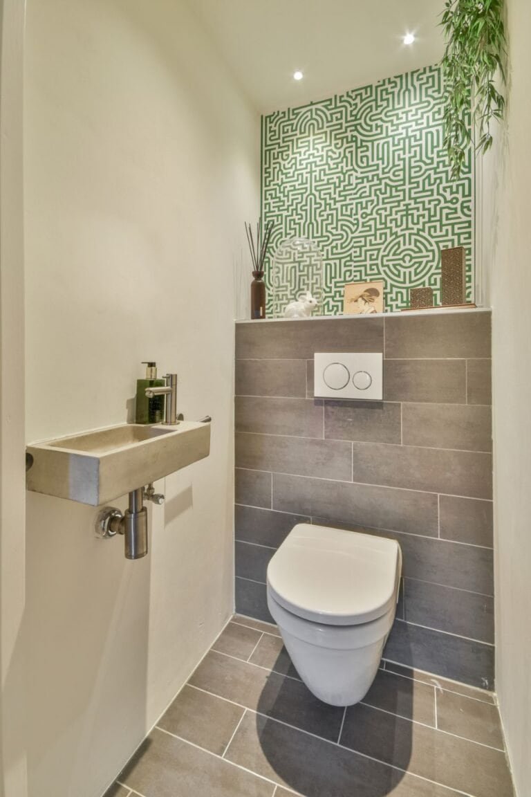 half bathroom wallpaper ideas - A modern bathroom with a toilet and sink